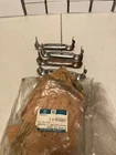 GM#90220657 Nos 88-89 Pontiac Lemans 4 Lower Intermediate Exhaust Pipe Brackets New. Price: $25.00.